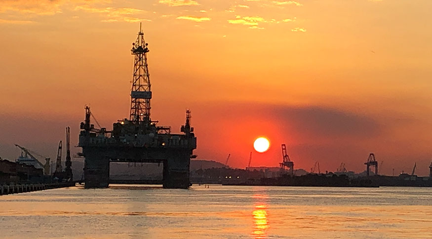 #PraCegoVer silhueta de plataforma de petróleo ao por do sol